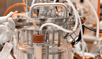 Progress in the Development of Aqueous Two-Phase Systems Comprising Ionic Liquids for the Downstream Processing of Protein-Based Biopharmaceuticals